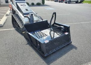 small skid steer landscape rock rake attached to bobcat
