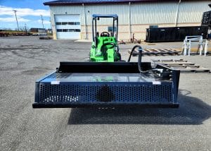 skid steer landscaping rock rake attached to avant 700 series tractor